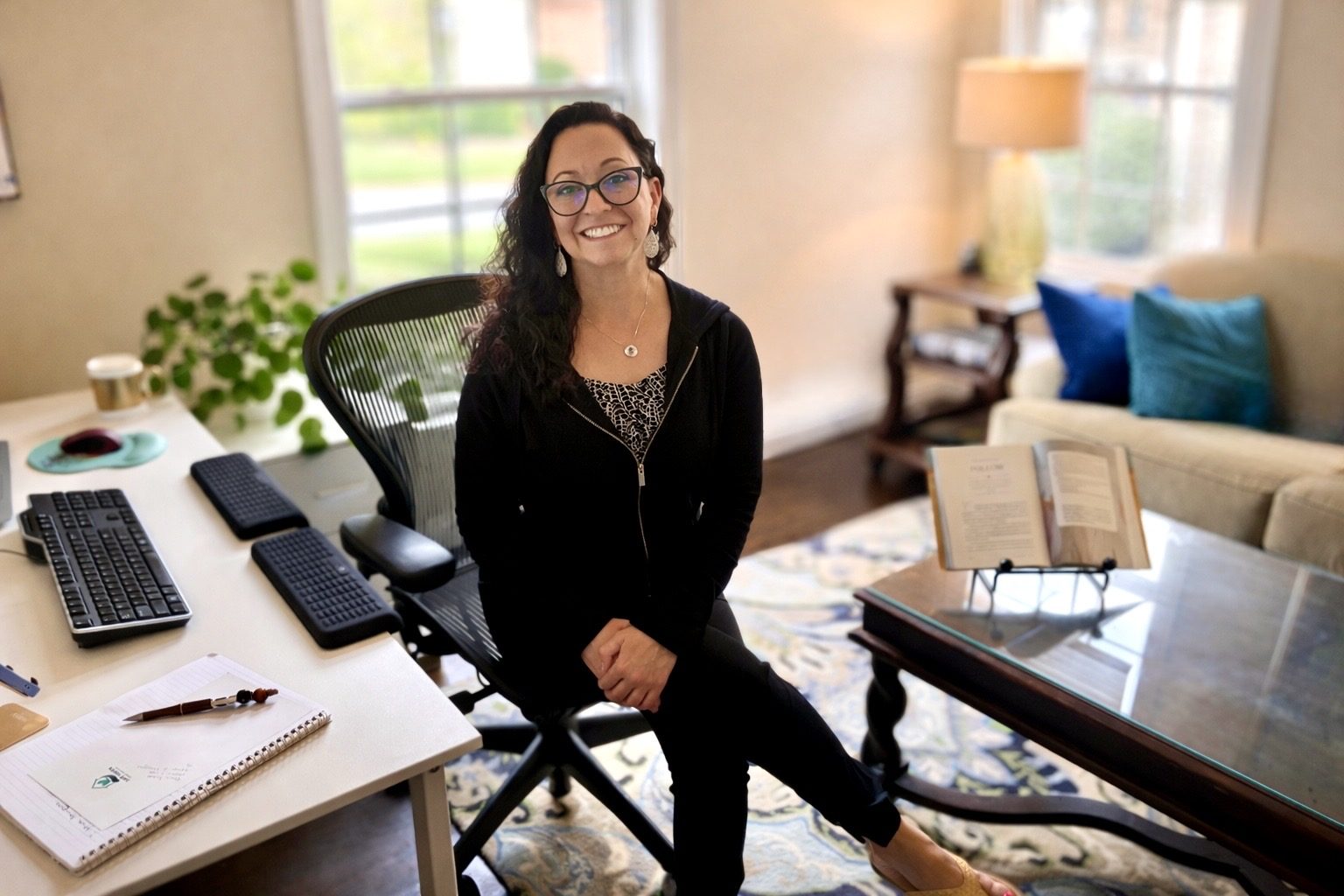 Summer Patel, Occupational Therapist, sitting at her desk in her home office.
